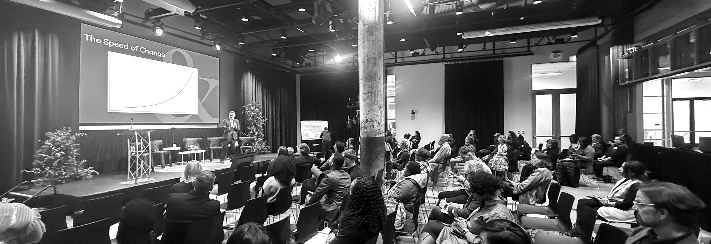 A full room of attendees listening as Matt Elliott presents The Speed of Change