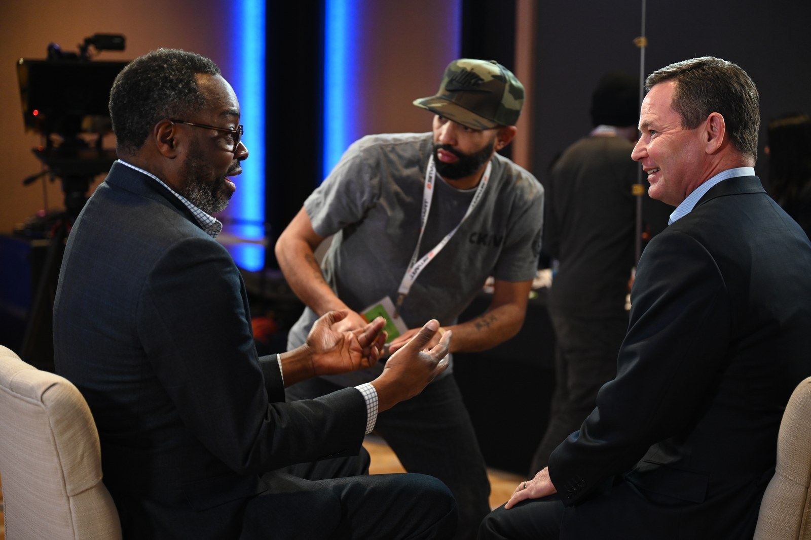 Matt Elliott laughing with a fellow speaker backstage before an interview